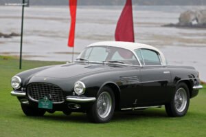 : A sleek 1952 Ferrari 342 America Cabriolet PF shines with its elegant lines and vibrant red finish, a symbol of royal craftsmanship.